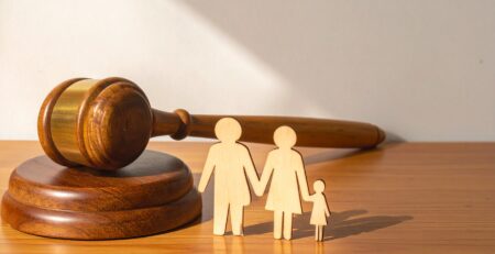 Wooden Judge Gavel and Sound Block Next to a Wooden Family Cutout