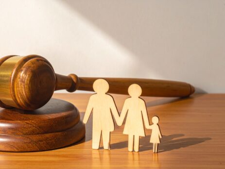 Wooden Judge Gavel and Sound Block Next to a Wooden Family Cutout