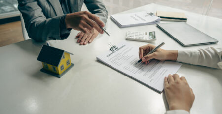 Two individuals looking over paperwork